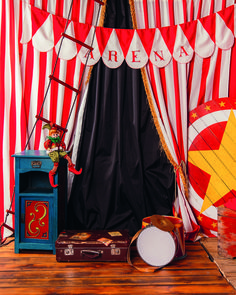 there is a circus tent with red and white striped curtains on the wall, along with other decorations