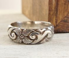 Christmas Cut off is December 5th for made to order items. Ready to ship items will be cut off Dec 15th Want 20% off this item? Go here to claim your coupon code! https://pintody.com/pages/discounts This Wide Wedding Band in Sterling Silver Ring with Scroll Floral embossed. Made of sterling silver that has been textured with flowers and scroll work this band can be made to order in your size. Great to use as a wedding band, a stacking ring, and pretty enough to wear alone. The ring is wide enoug Cute Jewelry Rings Silver, Ornate Stamped Jewelry For Wedding, Ornate Stamped Wedding Jewelry, Victorian Silver Jewelry With Decorative Band, Cute Jewelry Rings, Jewelry Rings Silver, Deco Flowers, Wide Wedding Rings, Silver Bands