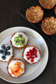 four muffins with yogurt, fruit and granola on a plate