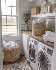 a washer and dryer in a small laundry room with baskets on the shelves