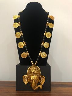 Beautiful Ganesha long necklace. Made out of aluminium and resin beads. Light in weight . Awesome necklace to gift your loved ones. Length of necklace:- 17 and half inch. Length of pendant :- 4 and half inch. Metal Necklace With Large Beads For Gift, Handmade Black Necklace For Festivals, Handmade Black Necklaces For Festivals, Gold Long Necklace For Festivals And Gifts, Gold Long Necklace As Festival Gift, Gold Long Necklace Gift For Festivals, Spiritual Long Necklace For Festivals, Long Beaded Necklaces For Festivals, Long Necklaces For Rituals And Festivals