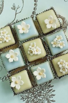 there are many square cookies with flowers on them