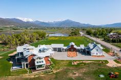 an aerial view of a large home with mountains in the background