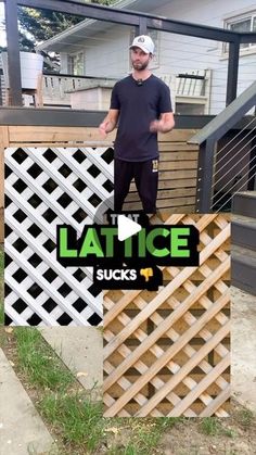 a man standing on top of a wooden fence next to a building with lattice design