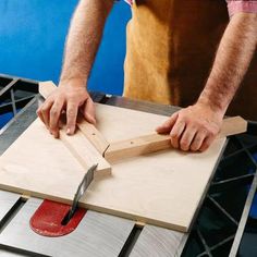 a man using a table saw to cut wood with a large piece of plywood