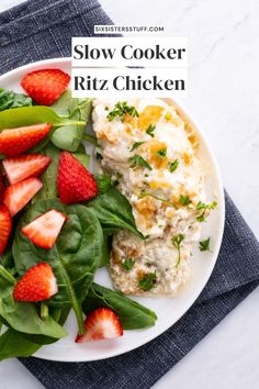 a white plate topped with spinach and strawberries