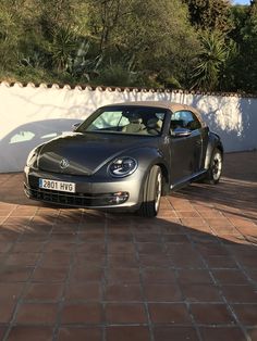 a car parked in front of a white wall