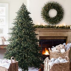 a christmas tree in a living room next to two wicker baskets