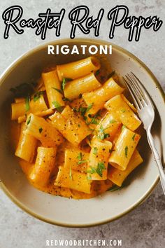 a white bowl filled with pasta next to a fork