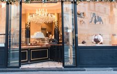 a store front with a cake in the window