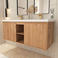 a bathroom vanity with two mirrors above it and a vase on the counter next to it