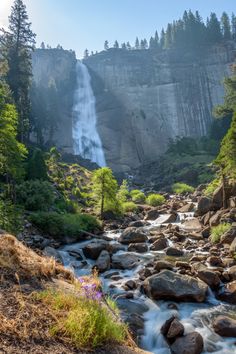 a waterfall in the middle of a forest