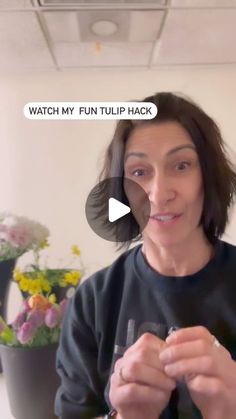 a woman holding a wine glass in front of her face with the caption watch my fun tulip hack