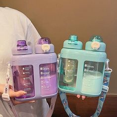 two water bottles in the shape of purses, one blue and one purple with handles