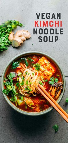 vegan kimchi noodle soup in a bowl with chopsticks on the side