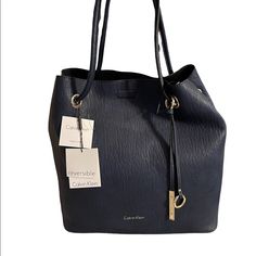 Calvin Klein Gabrianna Bubble Lamb North/South Key Item Tote Reversible: Navy On One Side And Black On The Other Includes Matching Pouch Medium Sized Bag; 13"W X 13-1/2"H X 6"D 12"L Double Handles Magnetic Snap Closure Silver-Tone Exterior Hardware Calvin Klein Tote Bag, Black Tote Purse, Woven Leather Tote, Calvin Klein Handbags, Exterior Hardware, Color Block Tote, Red Tote Bag, Calvin Klein Bags, Calvin Klein Bag