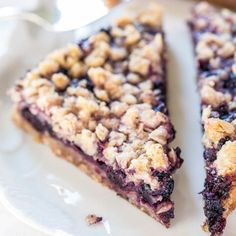 two slices of blueberry crumb pie on a white plate