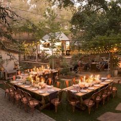 an outdoor dining area is set up for dinner with candles lit on the tables and chairs