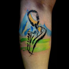 a tattoo on the arm of a person with a yellow and blue helmet in it