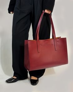 Named after the neighboring town to our Italian Factory, the Tolentino Tote is the epitome of upcycled luxury. Seamlessly lined in Hermés leftover leathers, its double-face construction is lightweight and spacious, easily fitting a 16" laptop (measured diagonally). Designed to stand upright when you put it down, it's structured but not stiff. A barely noticeable exterior slash pocket perfectly holds your phone, while convenient interior pockets hold your sunglasses and more, not to mention the interior key rings. A magnetic snap closure provides easy access to the effortless organization. This quiet luxury tote bag is thoughtfully designed to quietly work hard while you're working hard.