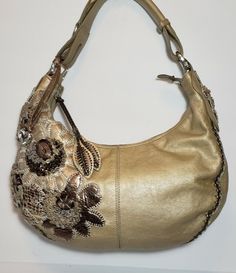 UNIQUE MUTIMEDIA 3D EMBELLISHED LEATHER APPLIQUE RARE CHAMPAGNE BEIGE GOLE MATALIC BRIGHTON FABIOLA PEWTER LEATHER FLORAL APPLIQUE MULTIMEDIA HOBO HANDBAG PURSE Ret $450 I LOVE THE BACK HIDDEN POCKET IN THESE BAGS AND THE ADJUSTABLE STRAP IT HAS A CLIP THAT CAN BE UNDONE AND STRAP UNFOLDS TO USE AS A LONGER SHOULDER BAG.TASSELED HANDSTICHED EMBROIDERED EMBELLISHED EMBOSSED HANDTOOLED LEATHER APPLIQUE EACH BAG TAKES OVER 12 HOURS TO CREATE. BAG IS IN EXCELENT PREOWNED CONDITION, BRIGHTON MASTERPI Formal Embellished Leather Shoulder Bag, Gold Rectangular Hobo Bag For Formal Occasions, Formal Gold Hobo Bag With Detachable Handle, Gold Hobo Bag With Detachable Handle For Formal Occasions, Elegant Silver Hobo Bag, Elegant Silver Hobo Shoulder Bag, Designer Gold Hobo Shoulder Bag, Designer Gold Hobo Bag For Evening, Designer Gold Hobo Bag For Evenings