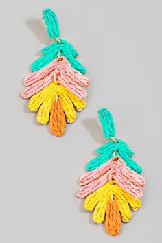 two pairs of multicolored earrings with braids hanging from each earring, on a gray background