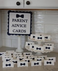 there is a sign that says parent advice cards next to some little boxes with bow ties on them