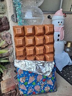 a pile of chocolates sitting next to a snowman