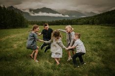 four children are playing in the grass with each other