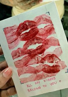 someone is holding up a piece of paper with lipstick drawn on it that says, all my kisses belong to you