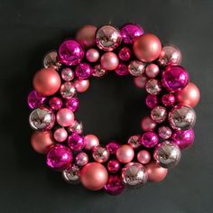 a pink and silver christmas ornament wreath