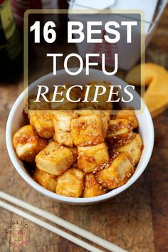 a white bowl filled with tofu next to chopsticks