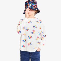 Spring has sprung—in the form of a super soft sweatshirt! Makes a great seasonal layer and features our new bright bloom print, which pretty much feels like a wearable kaleidoscope of joy and color. P.S. Comes in grown-up sizes, too! Fabric: 100% cotton French terry; pre-washed to minimize shrinkage. Feel: Super soft and comfortable, with a natural thickness that stands up to play. Spring Playful Patterned Tops, Playful Multicolor Graphic Print Sweatshirt, Playful Patterned Tops For Spring, Playful White Sweatshirt For Fall, Playful Multicolor Cotton Sweatshirt, Playful Crew Neck Sweatshirt For Spring, Fun Multicolor Long Sleeve Sweatshirt, Playful Long Sleeve Sweatshirt For Spring, Playful Multicolor Spring Sweatshirt