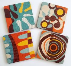 four square coasters with abstract designs on them