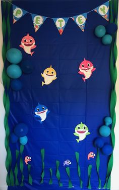 an under the sea theme for a birthday party with balloons and streamers on it