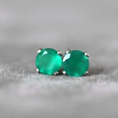 Green Onyx stud earrings. Little emerald green stone earrings. May birthstone Gift. This precious Green Onyx sparkles from the centre of a delicate 14k sterling silver claw setting. These excellent quality, flawless, green onyx gems are a lovely shade of emerald green and will add a splash of colour and fun to your outfits. These little stud earrings have a matching butterfly backs. Alaso available in 14k gold filled or 14k Gold finish. Available stone sizes: 4mm Gemstone shape: brilliant round Green Round Earrings For May Birthstone, Green Earrings For May Birthstone, Classic Green Hypoallergenic Jewelry, Green Emerald Round Earrings, Green Gemstone Earrings For Anniversary, Green Stone Earrings, Emerald Green Stone, Emerald Green Earrings, Onyx Jewelry