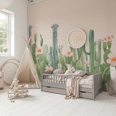 a child's room decorated in pink, green and white with cactus wallpaper