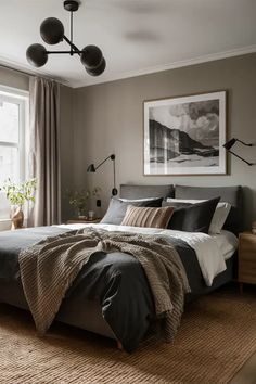 a bedroom with a large bed and two lamps hanging from the ceiling, along with an area rug on the floor