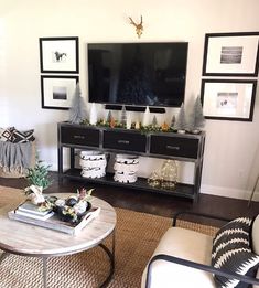 the living room is decorated for christmas with black and white accessories on top of it