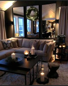 a living room filled with lots of furniture and candles on top of it's coffee table