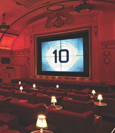 an empty theater with rows of seats in front of a large screen displaying the number ten