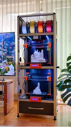 an image of a 3d printer in the middle of a room with other items on it