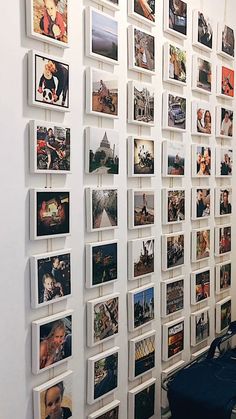 a wall with many pictures hanging on it