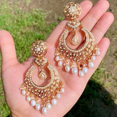 A pair of pearl chandbali earrings in 925 silver with gold plating. This classic combination of luxurious 925 silver and gold plating ensures the earrings are strong and long-lasting, and adds an eye-catching sparkle to your look. Metal: 92.5% silver Weight - 30 GMs, Height - 7.8 cm , Width- 3.75 cm Luxury Chandbali Pearl Necklace With Stone Work, Elegant Cheap Chandbalis For Wedding, Luxury Fusion Chandbali Bridal Earrings, Luxury Chandbali Jhumkas, Luxury Heavy Chandbalis For Diwali, Luxury Kundan Chandelier Chandbali Earrings, Luxury Hand Set Chandbali Chandelier Earrings, Luxury Ornate Chandbali Bridal Earrings, Luxury Chandbali Jewelry Sets With Latkans