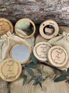 personalized wooden mirrors and pouches on top of burlocked fabric with greenery