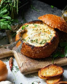 bread with cheese and herbs is on a cutting board