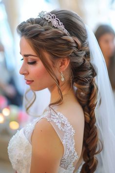 a woman in a wedding dress with a tiara on her head and braided hair