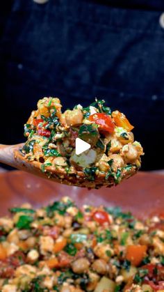 a spoon full of food on top of a wooden table