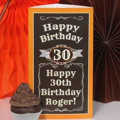 a happy birthday card with a chocolate cupcake next to an orange and brown fan