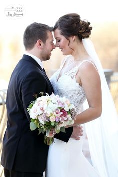 a bride and groom pose for a wedding photo